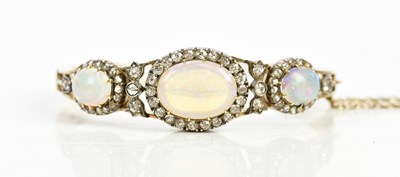 Lot 398 - A Victorian opal and diamond set hinged snap...