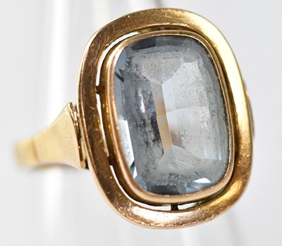 Lot 1105 - A 14ct gold ring with bezel set blue topaz,...