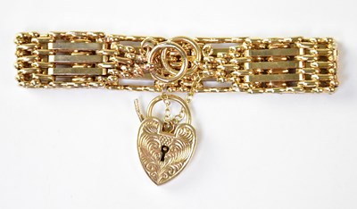 Lot 1150 - A 9ct gold three-bar gate bracelet with 9ct...