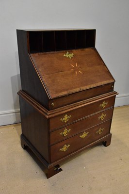 Lot 1020 - An unusual Georgian oak bureau on chest, the...