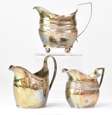 Lot 939 - Three silver helmet-shaped milk jugs,...