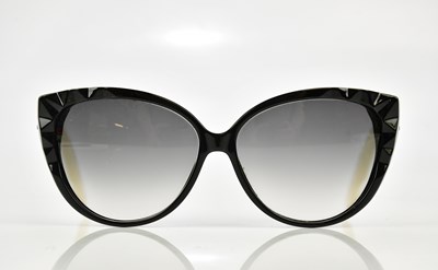 Lot 841 - SWAROVSKI; a pair of black and cream...