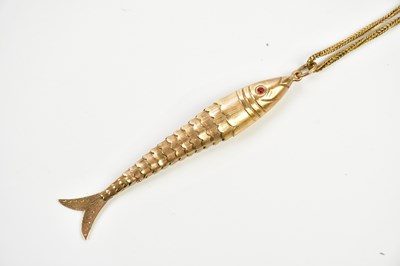 Lot 254 - A 9ct gold articulated fish pendant with gem...