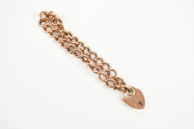 Lot 431 - A 9ct rose gold bracelet with padlock, approx...