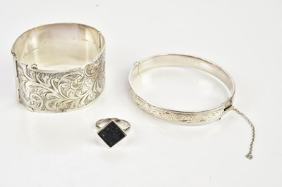 Lot 496 - Two silver oval hinged bangles and a...