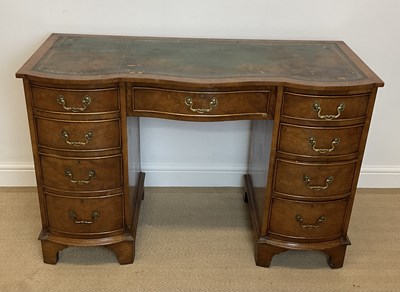 Lot 522 - A mahogany serpentine fronted knee-hole desk,...