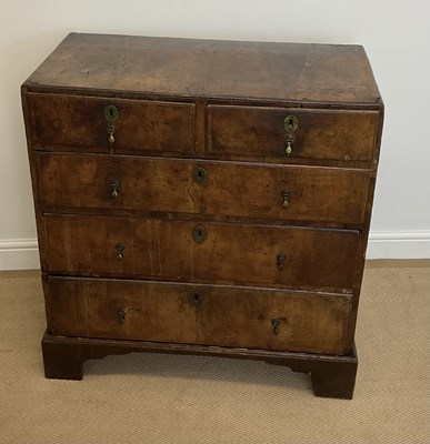 Lot 477 - An 18th century walnut chest of two short over...