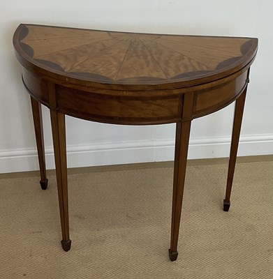 Lot 527 - An Edwardian satinwood demi-lune fold-over...