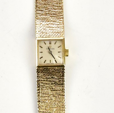 Lot 565 - OMEGA; a lady's 9ct gold wristwatch with baton...