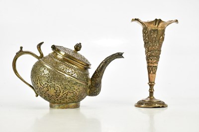 Lot 2054 - An Eastern white metal teapot with foliate...