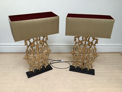 Lot 1254 - A pair of gilt metal ornate table lamps with...