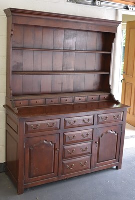 Lot 1232 - A reproduction oak dresser with boarded plate...