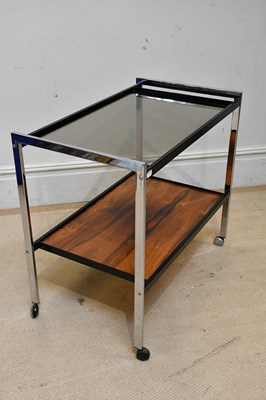 Lot 8 - HOWARD MILLER; a retro chrome two tier trolley...