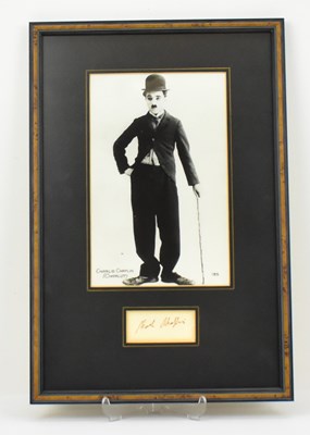 Lot 1581 - CHARLIE CHAPLIN; a mounted display featuring a...