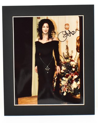Lot 1679 - CHER; a signed colour photograph depicting...