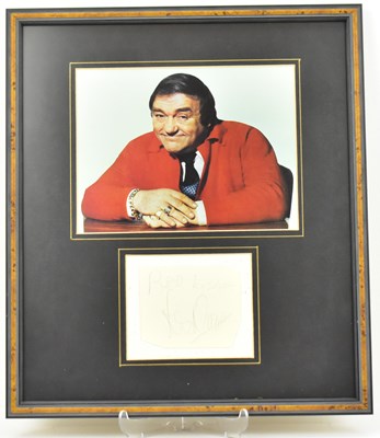 Lot 1711 - LES DAWSON; a framed display featuring a...