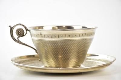 Lot 2069 - A French silver teacup and saucer with engine...