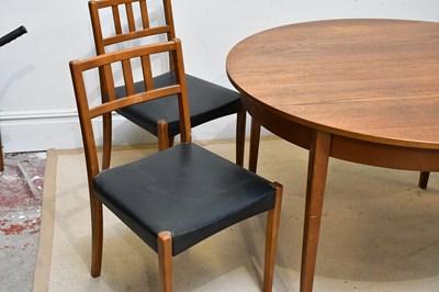 Lot 13 - A mid century teak extending circular dining...