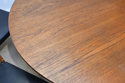 Lot 13 - A mid century teak extending circular dining...