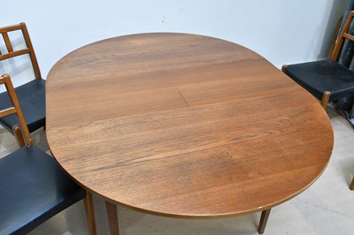 Lot 13 - A mid century teak extending circular dining...