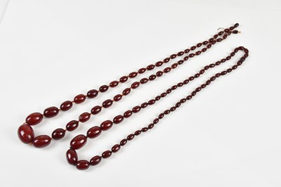 Lot 1623 - Two cherry amber coloured beaded necklaces,...