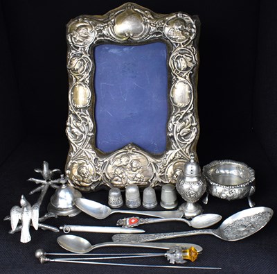 Lot 627 - A Keyford Frames Ltd hallmarked silver cherub and floral bordered picture frame