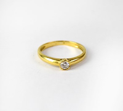 Lot 783 - A yellow metal ring set with solitaire diamond