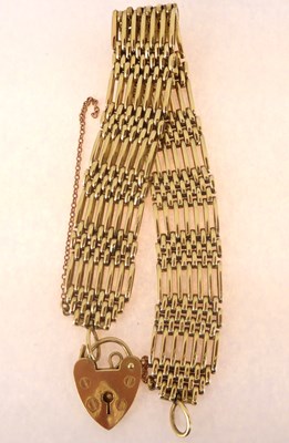 Lot 785 - A 9ct gold seven bar gate bracelet with 9ct...