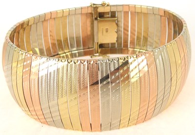 Lot 786 - A 9ct gold three-colour semi-rigid bracelet...