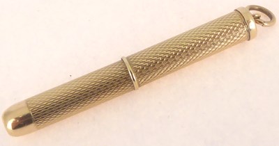 Lot 852 - A 9ct gold extending toothpick with engine...