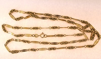 Lot 821 - A 9ct gold bar and knot necklace with ring...