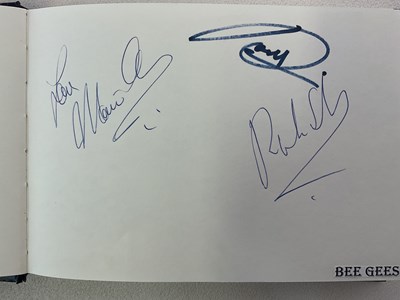Lot 1594 - An autograph album with pages signed by...