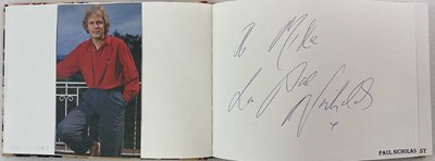 Lot 1599 - An autograph album with pages signed by music...