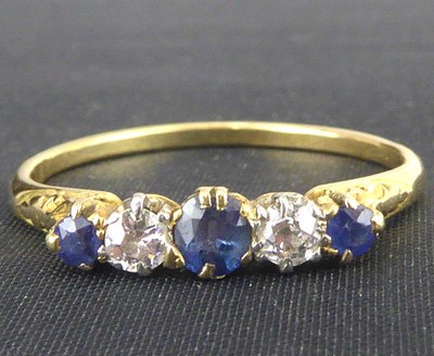 Lot 733 - A 9ct gold diamond and sapphire ring