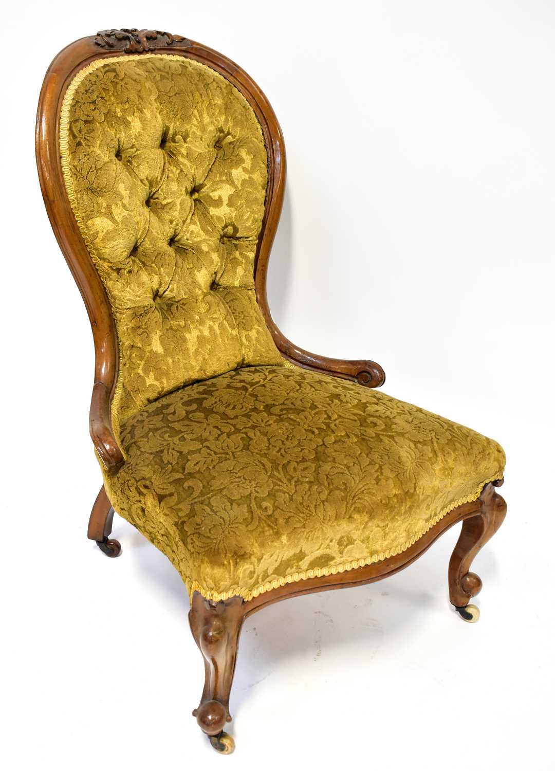 Lot 16 - A Victorian walnut button back nursing chair...