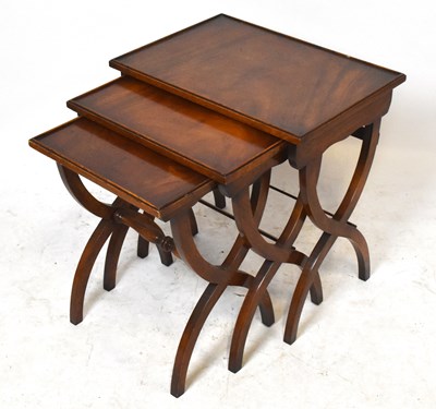 Lot 1726 - A reproduction mahogany nest of three tables,...