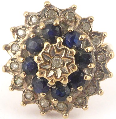 Lot 741 - A 9ct gold diamond and sapphire cluster ring,...
