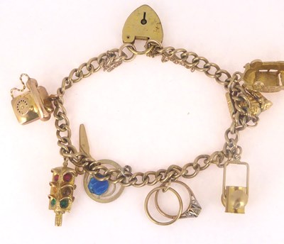 Lot 799 - A gold plated charm bracelet with seven 9ct...