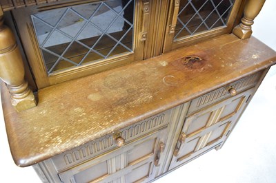 Lot 5 - An Ercol-style elm court cupboard with a pair...