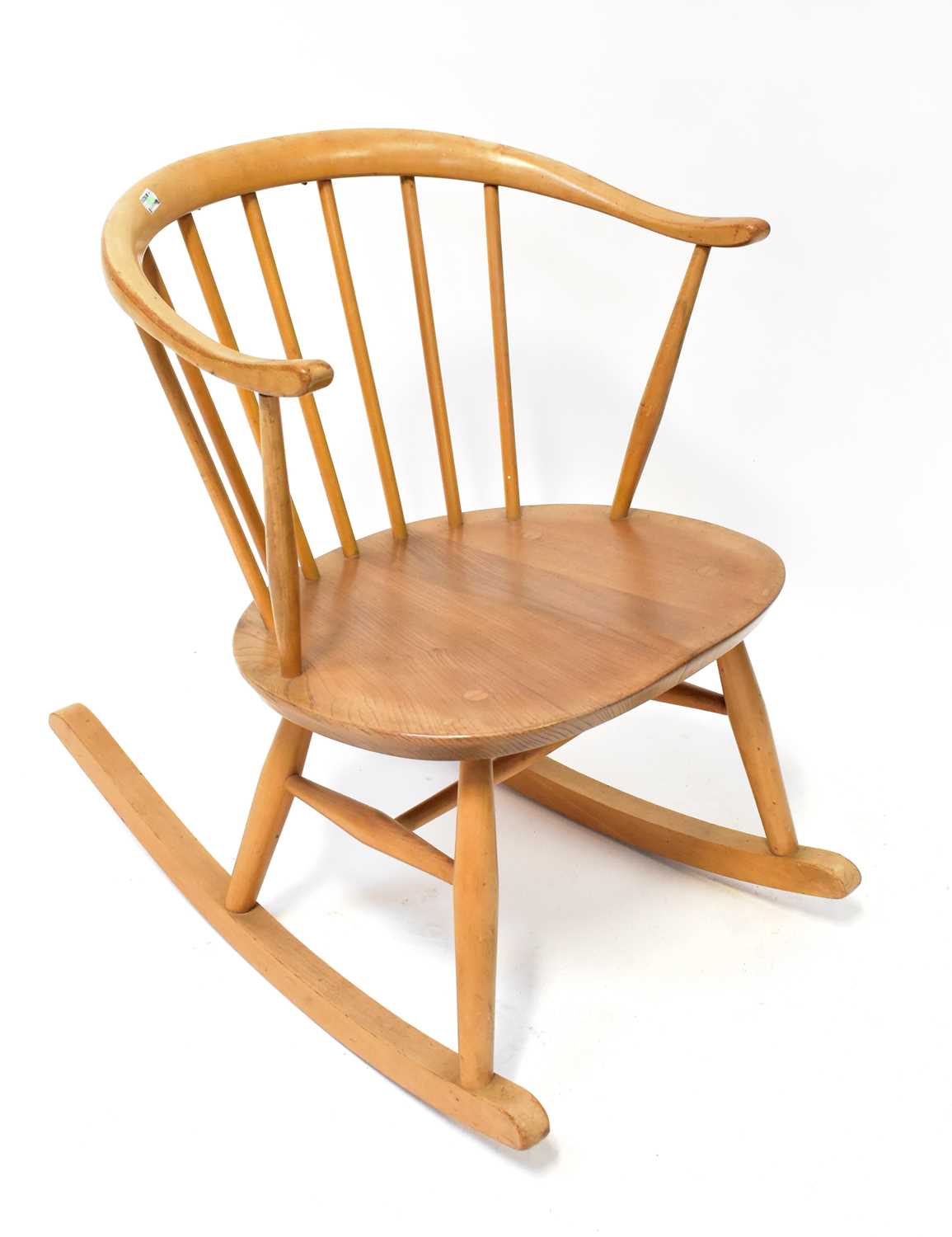 Lot 20 - ERCOL; a light elm rocking chair with...