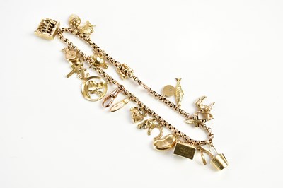 Lot 1538 - A 9ct yellow gold charm bracelet, set with...