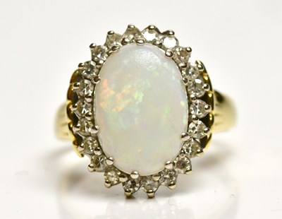 Lot 1310 - An 18ct yellow gold opal and diamond set oval...