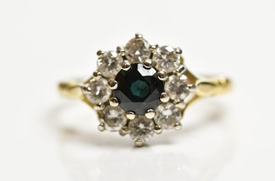 Lot 1352 - An 18ct yellow gold diamond and sapphire...