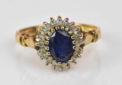 Lot 1238 - A 9ct gold sapphire and diamond oval cluster...