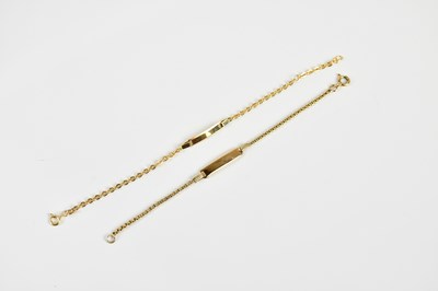 Lot 1566 - Two yellow metal bracelets, each with a vacant...