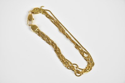 Lot 1560 - A yellow metal multistrand bracelet, stamped...