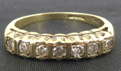 Lot 758 - A 9ct gold seven-stone diamond ring, the tiny...