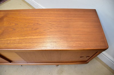 Lot 7 - A mid century teak sideboard with two sliding...