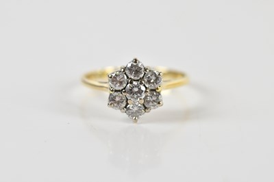 Lot 1355 - An 18ct yellow gold daisy set seven stone...