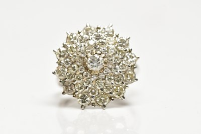 Lot 1289 - An 18ct white gold diamond stepped cluster...